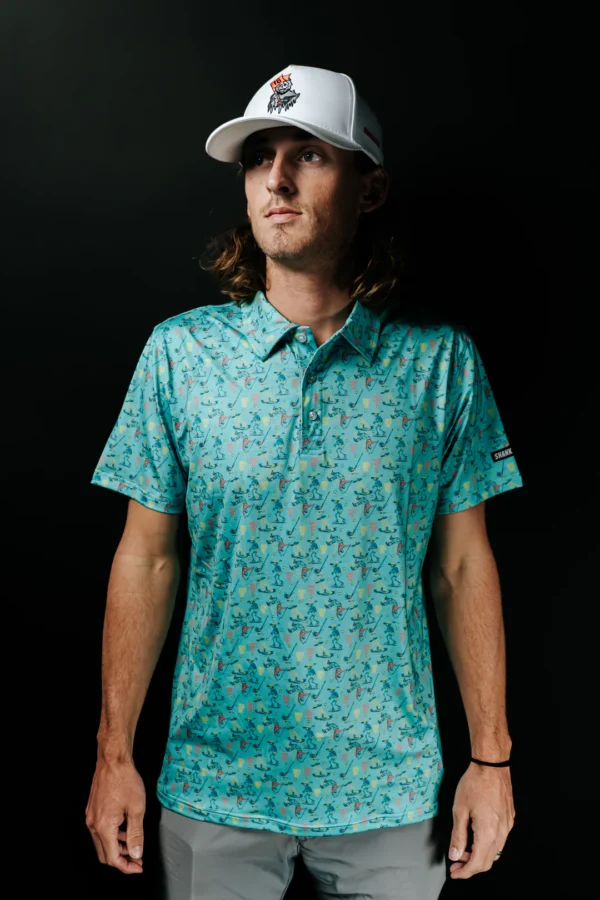 Person wearing turquoise patterned polo and white cap
