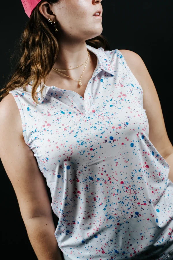 Person wearing sleeveless white splatter-pattern top