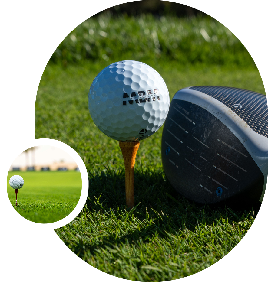 Golf ball on tee beside driver